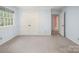 Blue bedroom with double closet and a door leading to another room at 2104 Stoneyridge Dr, Charlotte, NC 28214
