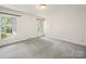 Bright bedroom with plush gray carpeting and windows offering natural light at 2104 Stoneyridge Dr, Charlotte, NC 28214