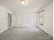 Spacious bedroom with soft gray carpet and traditional window trim at 2104 Stoneyridge Dr, Charlotte, NC 28214