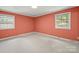 Cozy coral bedroom with natural light and plush carpeting at 2104 Stoneyridge Dr, Charlotte, NC 28214