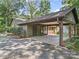 Attached carport has ample space for parking, featuring brick supports and mature landscaping at 2104 Stoneyridge Dr, Charlotte, NC 28214