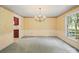 The dining room features a beautiful chandelier and classic wallpaper for elegant meals and entertaining at 2104 Stoneyridge Dr, Charlotte, NC 28214