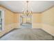 The dining room features a beautiful chandelier and classic wallpaper for elegant meals and entertaining at 2104 Stoneyridge Dr, Charlotte, NC 28214