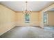 The dining room features a beautiful chandelier and classic wallpaper for elegant meals and entertaining at 2104 Stoneyridge Dr, Charlotte, NC 28214