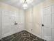 The foyer features a slate tile floor, white walls, and a unique light fixture for an elegant entrance at 2104 Stoneyridge Dr, Charlotte, NC 28214