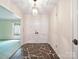 The foyer features a slate tile floor, white walls, and a unique light fixture for an elegant entrance at 2104 Stoneyridge Dr, Charlotte, NC 28214
