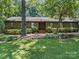 Charming one story home featuring beautiful landscaping and a welcoming entrance at 2104 Stoneyridge Dr, Charlotte, NC 28214