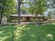 Charming single-story home with a well-manicured front lawn and inviting landscape at 2104 Stoneyridge Dr, Charlotte, NC 28214