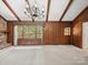 Spacious living room features wood accents, a brick fireplace, and a chandelier at 2104 Stoneyridge Dr, Charlotte, NC 28214