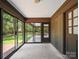 Cozy screened porch provides an outdoor retreat, perfect for enjoying the serene backyard view at 2104 Stoneyridge Dr, Charlotte, NC 28214