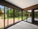 Relaxing screened porch offers panoramic views of the lush backyard and patio at 2104 Stoneyridge Dr, Charlotte, NC 28214
