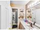 Bathroom with tiled sink backsplash, bronze faucet, and shelving at 2116 Bon Villa Way, Fort Mill, SC 29708