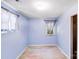 A blue bedroom featuring light wood flooring, two windows and light fixture at 2116 Bon Villa Way, Fort Mill, SC 29708