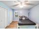 Comfortable bedroom with blue walls, wood-look floors, closet, and a ceiling fan at 2116 Bon Villa Way, Fort Mill, SC 29708
