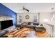 Cozy living room featuring a stone fireplace, plush sectional sofa, and modern ceiling fan at 2116 Bon Villa Way, Fort Mill, SC 29708