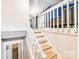 Bright staircase with white rails and wood treads, leading to the upper level of the home at 2116 Bon Villa Way, Fort Mill, SC 29708