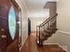 Inviting foyer showcasing hardwood floors, an elegant staircase, and a stained-glass front door at 228 31St Avenue Ne Ct, Hickory, NC 28601