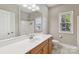 Well-lit bathroom featuring a large vanity with sink, mirror, and a shower/tub combo at 2411 Stoney Run Dr # 13, Oakboro, NC 28129