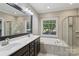 Bathroom featuring a double sink vanity, a large soaking tub, and a walk-in shower at 2411 Stoney Run Dr # 13, Oakboro, NC 28129