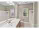 Well-lit bathroom featuring a large vanity with sink, mirror, and a shower/tub combo at 2411 Stoney Run Dr # 13, Oakboro, NC 28129