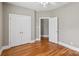Bedroom featuring hardwood floors and a double-door closet for ample storage at 2411 Stoney Run Dr # 13, Oakboro, NC 28129