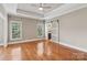 The spacious bedroom boasts tray ceilings, hardwood floors and natural light, creating a relaxing retreat at 2411 Stoney Run Dr # 13, Oakboro, NC 28129