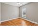 Bright bedroom with hardwood floors, neutral walls, and a window overlooking the yard at 2411 Stoney Run Dr # 13, Oakboro, NC 28129