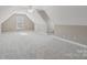 Bright bonus room with neutral carpet, natural light, and vaulted ceilings at 2411 Stoney Run Dr # 13, Oakboro, NC 28129
