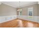 Bright dining room with hardwood floors, classic wainscoting, and an elegant chandelier at 2411 Stoney Run Dr # 13, Oakboro, NC 28129