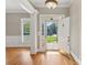 Elegant foyer with hardwood floors, white trim, and view through the front door at 2411 Stoney Run Dr # 13, Oakboro, NC 28129