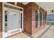 Close-up of the front entrance showing a glass-paneled door and classic brickwork at 2411 Stoney Run Dr # 13, Oakboro, NC 28129