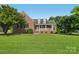 Charming brick home featuring a large front yard and inviting covered porch at 2411 Stoney Run Dr # 13, Oakboro, NC 28129