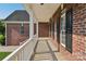 Spacious covered front porch with brick facade and white columns, offering ample outdoor space at 2411 Stoney Run Dr # 13, Oakboro, NC 28129