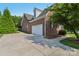 Brick home exterior highlighting an attached two-car garage and paved driveway at 2411 Stoney Run Dr # 13, Oakboro, NC 28129