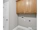 Practical laundry room with tiled floors and cabinet storage space at 2411 Stoney Run Dr # 13, Oakboro, NC 28129