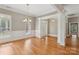 Bright living room featuring hardwood floors, large windows and elegant wainscoting detail at 2411 Stoney Run Dr # 13, Oakboro, NC 28129