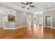 Open concept living room with hardwood floors, neutral paint, and seamless flow into other spaces at 2411 Stoney Run Dr # 13, Oakboro, NC 28129
