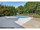 Beautiful backyard pool and patio area with mature trees at 2411 Stoney Run Dr # 13, Oakboro, NC 28129