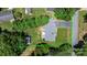 Aerial view of a property with a brick house, a well-maintained lawn, and mature trees surrounding the house at 2623 Ne 13Th Ne St, Hickory, NC 28601
