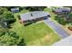 Aerial view of a brick home with a well-kept lawn, surrounded by mature trees and greenery at 2623 Ne 13Th Ne St, Hickory, NC 28601