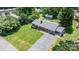 Aerial view of a single-story brick house with mature trees, a lush green lawn and a paved driveway at 2623 Ne 13Th Ne St, Hickory, NC 28601