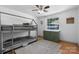 Well-lit bedroom featuring a bunk bed, wood flooring, and a calming color scheme at 2623 Ne 13Th Ne St, Hickory, NC 28601