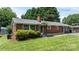 Quaint brick home featuring an inviting front porch, manicured landscaping, and charming window accents at 2623 Ne 13Th Ne St, Hickory, NC 28601