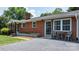 Charming brick home with a well-maintained lawn, tasteful front yard landscaping and outdoor seating area at 2623 Ne 13Th Ne St, Hickory, NC 28601