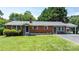 Charming brick home featuring a well-manicured lawn, classic design, and an inviting covered entrance at 2623 Ne 13Th Ne St, Hickory, NC 28601