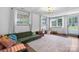 Bright living room with a green couch, lots of windows, and natural light at 2623 Ne 13Th Ne St, Hickory, NC 28601