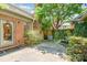Backyard area with greenery, brick walls, and trees providing shade and privacy at 2825 Sharon View Rd, Charlotte, NC 28210
