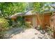 Backyard area with greenery, brick walls, and trees providing shade and privacy at 2825 Sharon View Rd, Charlotte, NC 28210
