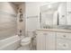 Bright bathroom with neutral tiling in the shower/tub, light colored vanity, and ample lighting at 2825 Sharon View Rd, Charlotte, NC 28210
