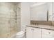 Bathroom featuring a glass shower, neutral tile, and vanity with granite counter and decorative backsplash at 2825 Sharon View Rd, Charlotte, NC 28210